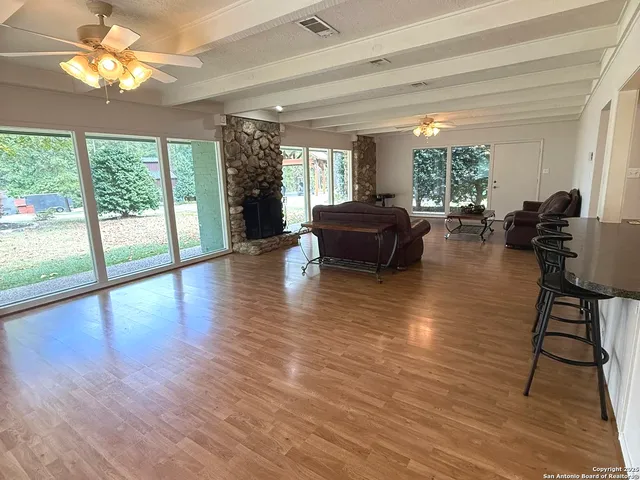 a living room with furniture and a floor to ceiling window