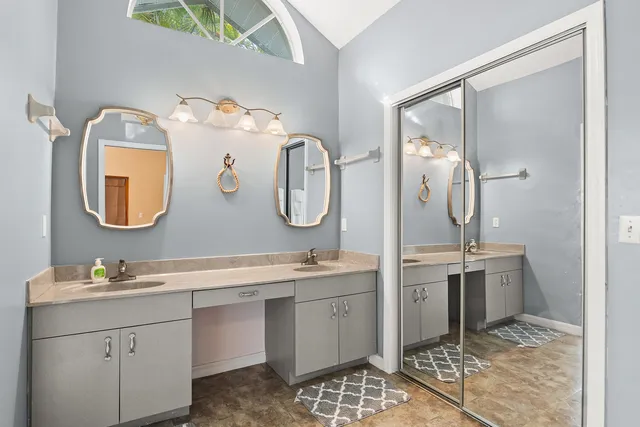a bathroom with a double vanity sink and a mirror