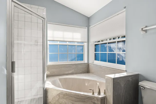 a bathroom with bathtub and window