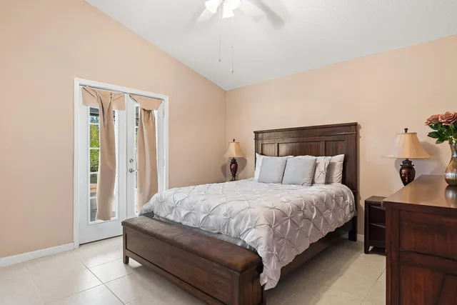 a bedroom with a bed and a potted plant