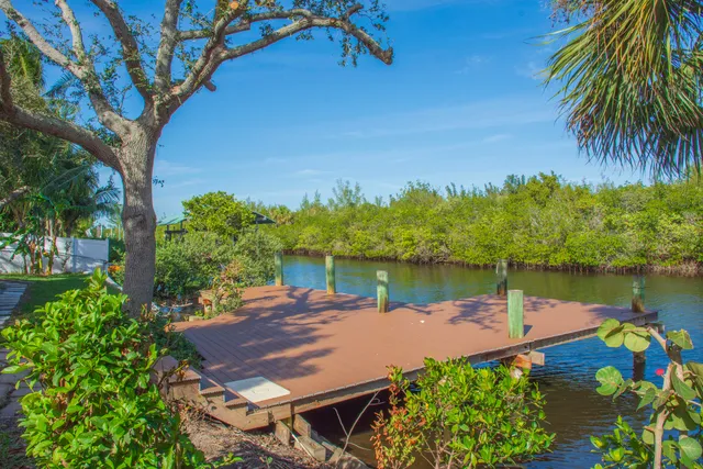 a view of a lake with a table and chairs
