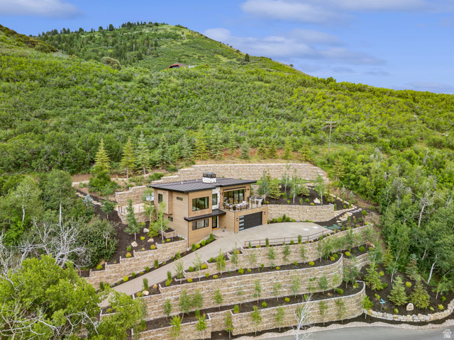 1400 Weber Wild Road Oakley, UT 84055 - Photo 5 of 55 Modern residence featuring a flat roofline, wood-finish siding, and a multi-level terraced landscape with retaining walls