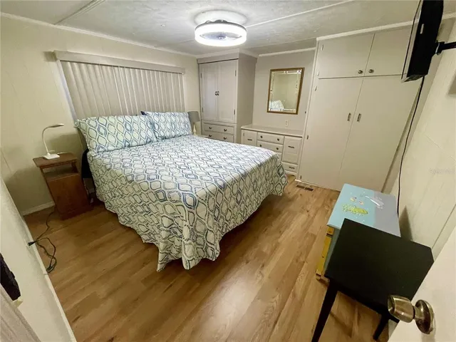 a bathroom with a sink a toilet a mirror a vanity and window