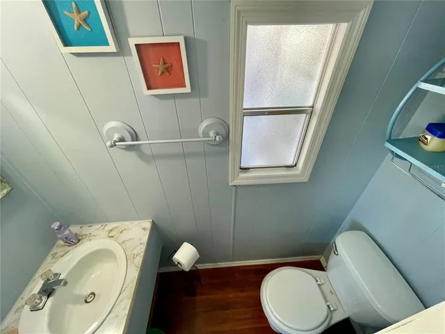 a bathroom with a sink toilet and mirror