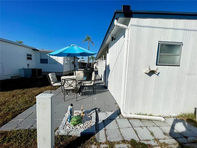 a backyard of a house with barbeque oven