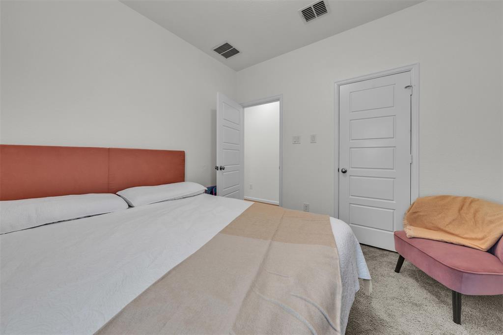 228 Palo Duro Bend Rhome, TX 76078 - Photo 14 of 35 a bedroom with a bed and a couch
