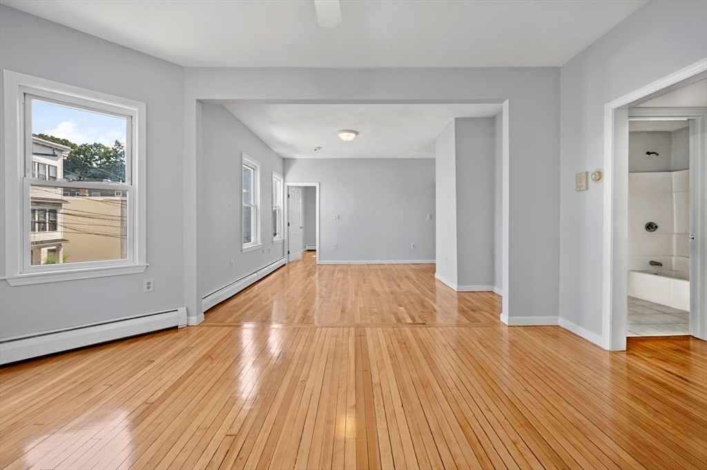 61 Shurtleff Street, Unit 4 Chelsea, MA 02150 - Photo 11 of 32 a view of empty room with wooden floor and fan