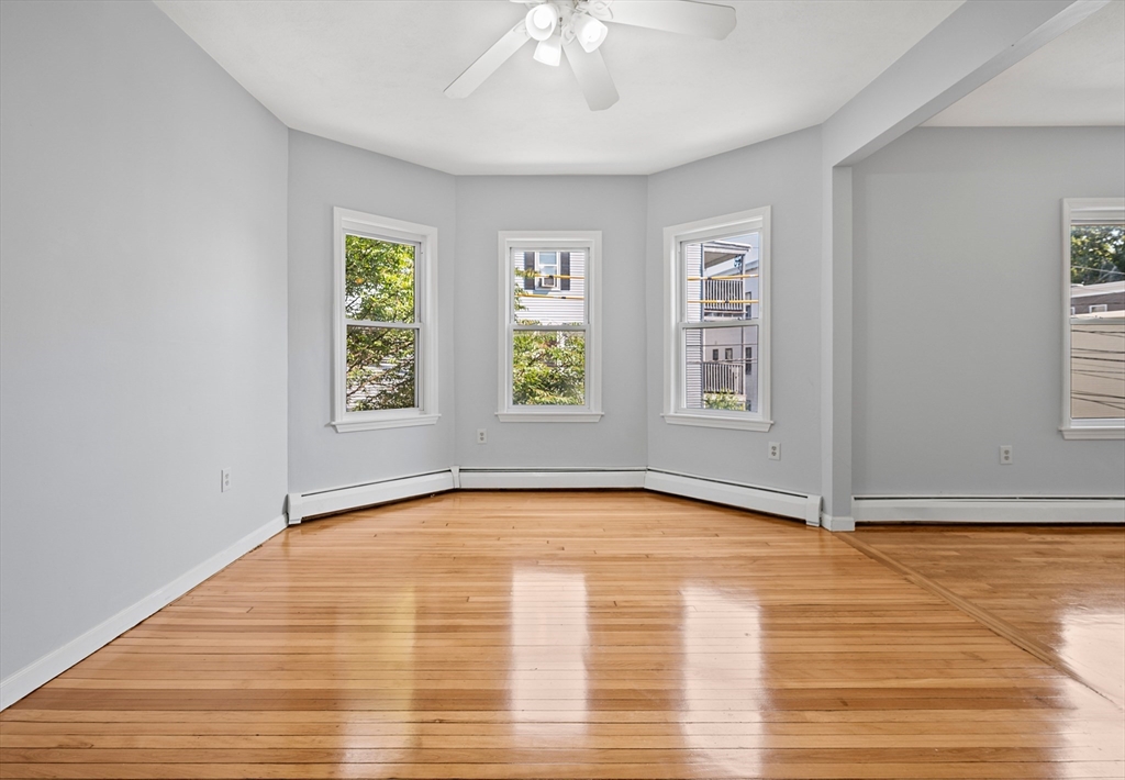 61 Shurtleff Street, Unit 4 Chelsea, MA 02150 - Photo 12 of 32 a view of an empty room with window and wooden floor