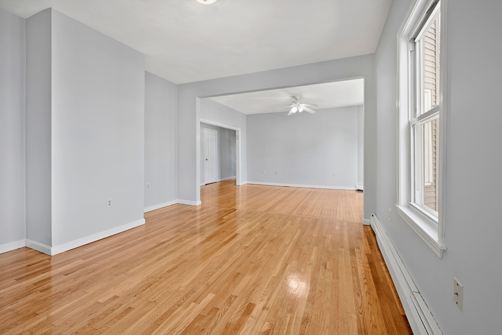 61 Shurtleff Street, Unit 4 Chelsea, MA 02150 - Photo 13 of 32 a view of an empty room with wooden floor and a window