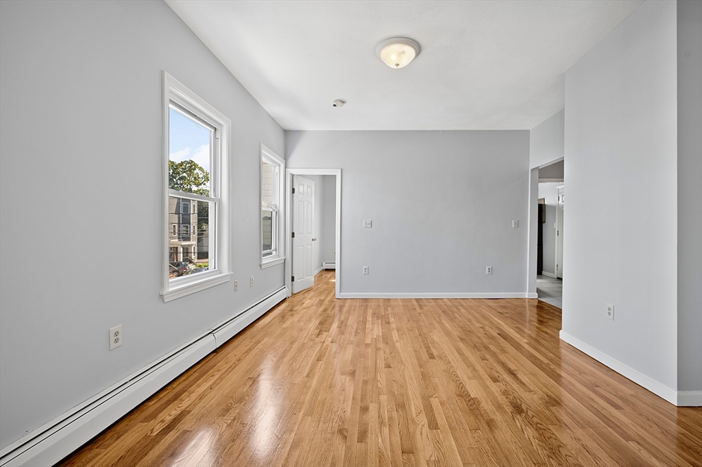 61 Shurtleff Street, Unit 4 Chelsea, MA 02150 - Photo 16 of 32 a view of an empty room with wooden floor and a window