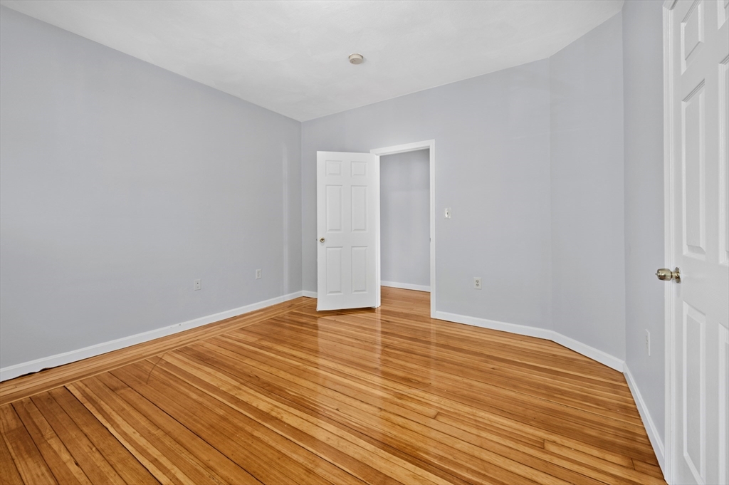 61 Shurtleff Street, Unit 4 Chelsea, MA 02150 - Photo 21 of 32 a view of an empty room with wooden floor