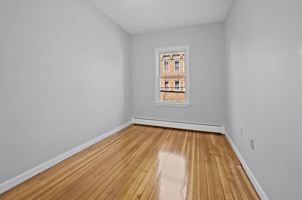61 Shurtleff Street, Unit 4 Chelsea, MA 02150 - Photo 25 of 32 a view of an empty room with wooden floor and a window