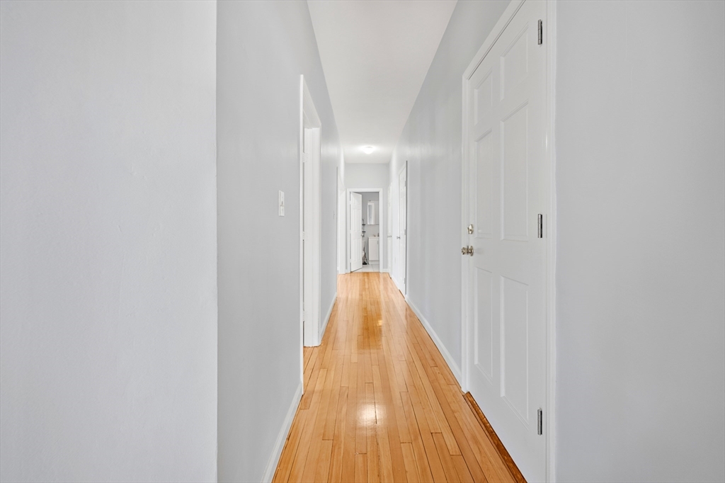 61 Shurtleff Street, Unit 4 Chelsea, MA 02150 - Photo 27 of 32 a view of a hallway with wooden floor
