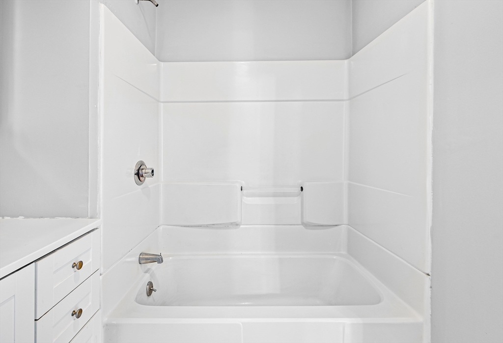 61 Shurtleff Street, Unit 4 Chelsea, MA 02150 - Photo 29 of 32 a white bath tub sitting next to a white sink and vanity