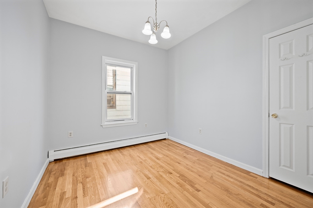 61 Shurtleff Street, Unit 4 Chelsea, MA 02150 - Photo 31 of 32 a view of empty room with wooden floor and fan