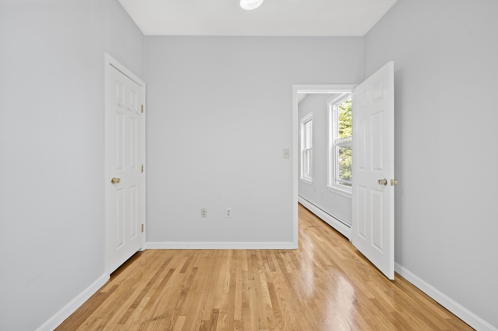 61 Shurtleff Street, Unit 4 Chelsea, MA 02150 - Photo 32 of 32 a view of an empty room with wooden floor and a window