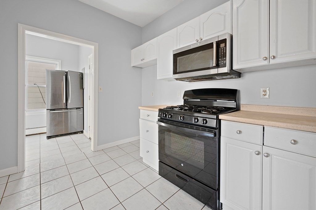 61 Shurtleff Street, Unit 4 Chelsea, MA 02150 - Photo 6 of 32 a kitchen with cabinets stainless steel appliances and a counter space