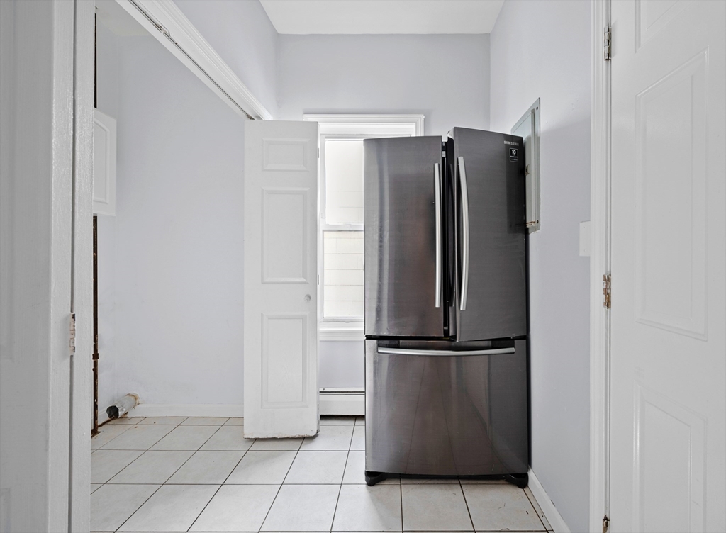 61 Shurtleff Street, Unit 4 Chelsea, MA 02150 - Photo 7 of 32 a view of a refrigerator in kitchen and a glass door