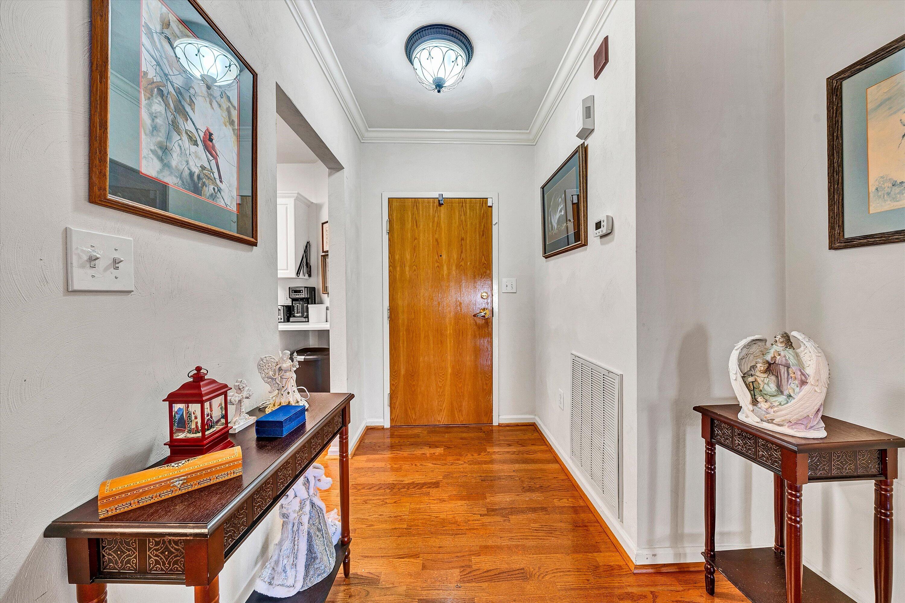 4434 Pheasant Ridge Road, Unit 101 Roanoke, VA 24014 - Photo 14 of 31 a view of a hallway with entryway wooden floor and front door