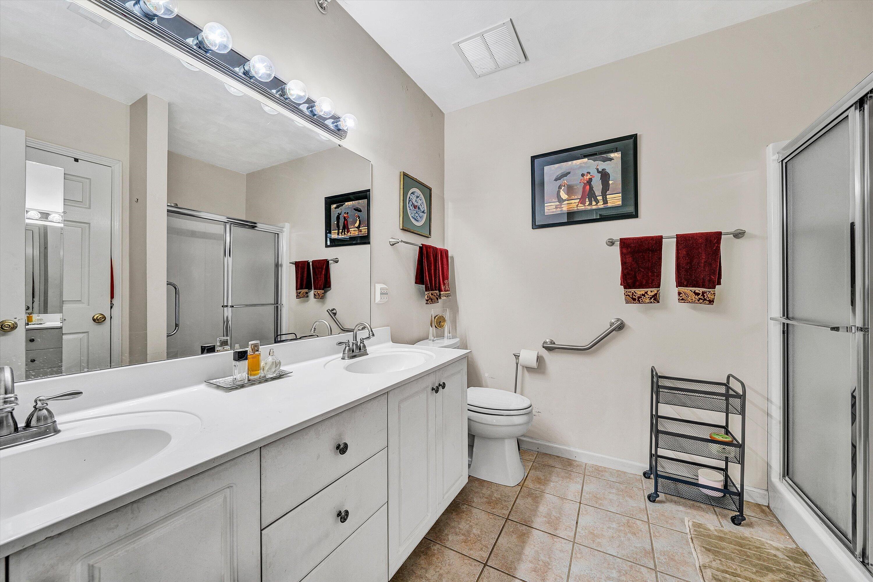 4434 Pheasant Ridge Road, Unit 101 Roanoke, VA 24014 - Photo 29 of 31 a spacious bathroom with a double vanity sink toilet and a mirror