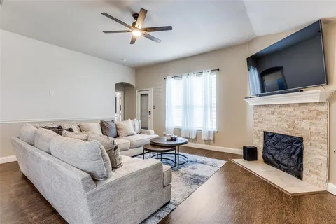 a living room with furniture fireplace and flat screen tv