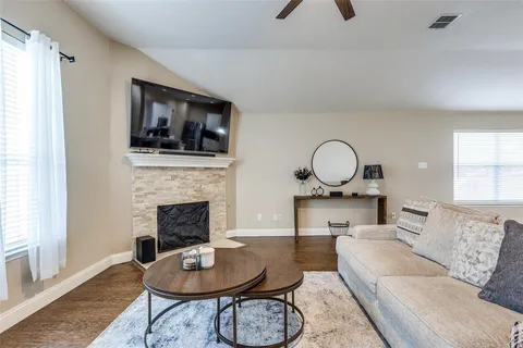 a living room with furniture a fireplace and a window