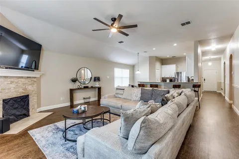 a living room with furniture a fireplace and a flat screen tv