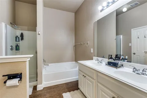 a bathroom with a tub sink and mirror