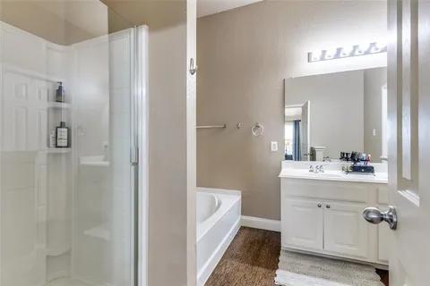a en suite bathroom with a double vanity sink a mirror and shower