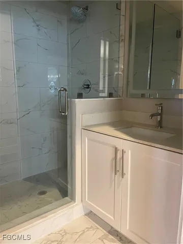 a bathroom with a sink and shower
