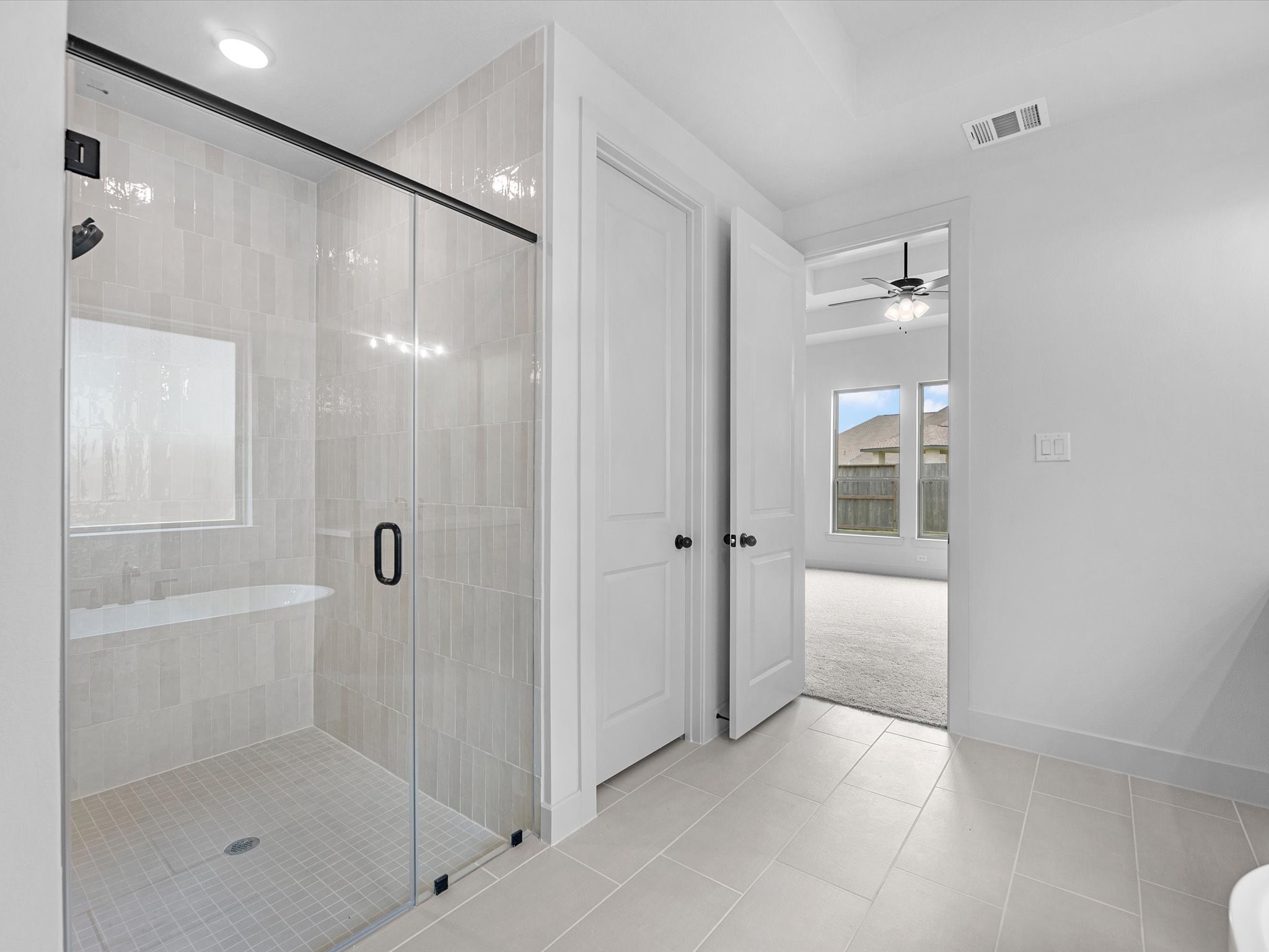 8915 Acropolis Lane Manvel, TX 77578 - Photo 15 of 32 a bathroom with a shower and a glass door