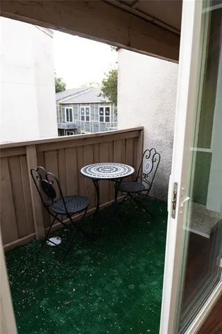 a view of a chairs and table in patio with a yard