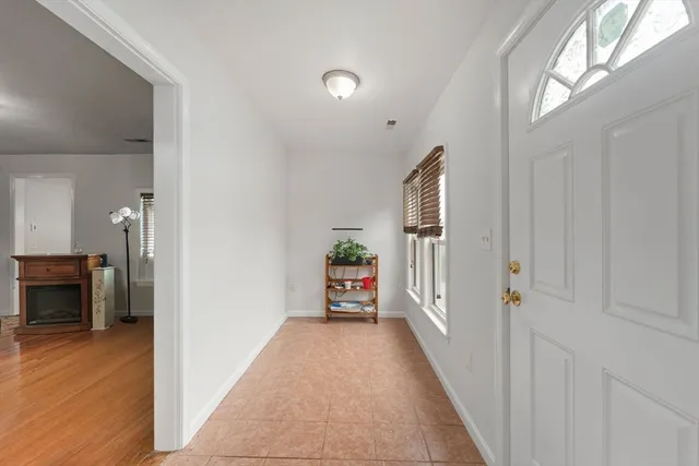 a view of a hallway view with wooden floor and furniture