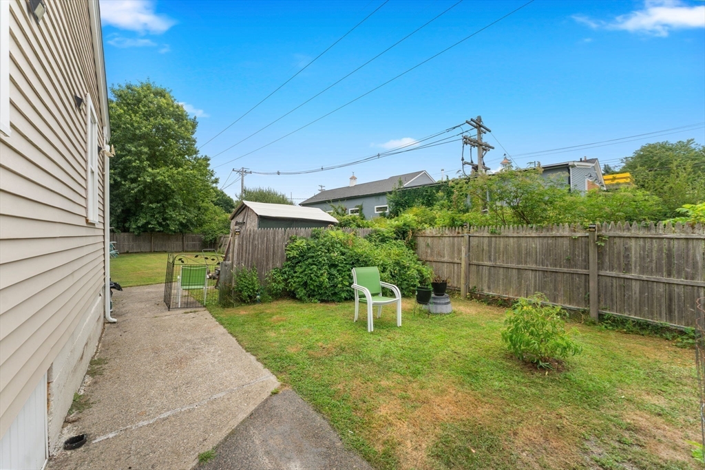 18 Edinboro Avenue Brockton, MA 02301 - Photo 28 of 28 a view of a backyard with plants and a slide