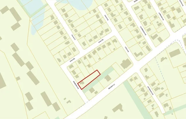 a white bed sitting next to a yellow curtain