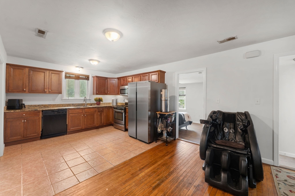 18 Edinboro Avenue Brockton, MA 02301 - Photo 5 of 28 a kitchen with stainless steel appliances a refrigerator and a stove top oven