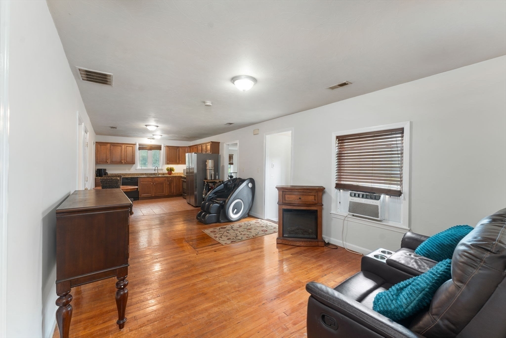 18 Edinboro Avenue Brockton, MA 02301 - Photo 7 of 28 a living room with furniture kitchen view and a wooden floor