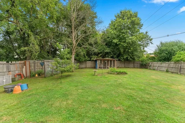 a view of a backyard with a garden and entertaining space