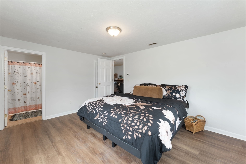 18 Edinboro Avenue Brockton, MA 02301 - Photo 10 of 28 a bedroom with a bed and wooden floor