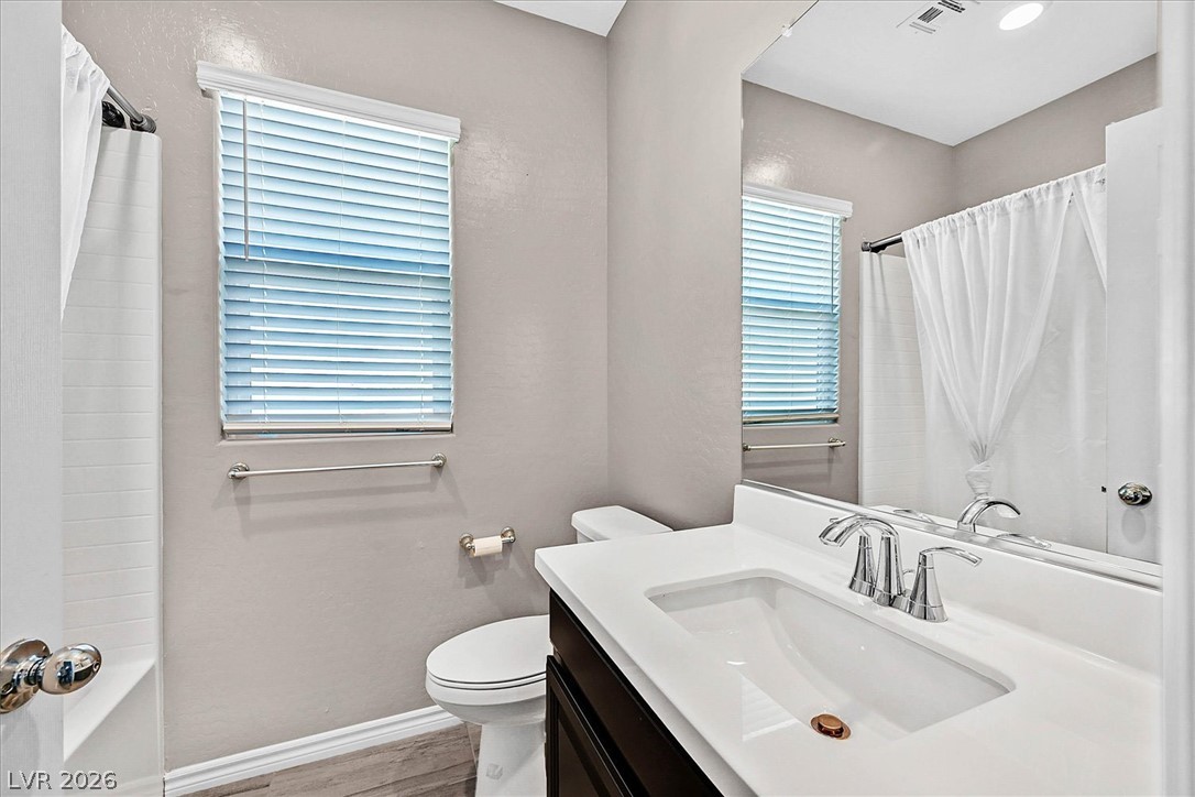 1106 Langston Ranch Avenue Henderson, NV 89002 - Photo 22 of 36 A pristine bathroom featuring contemporary fixtures and ample light from a window.