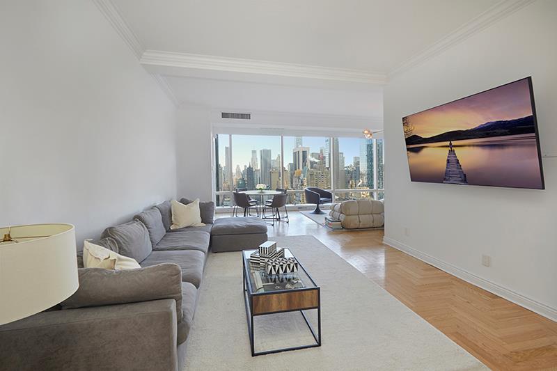 1 Central Park West, Unit 40CD Manhattan, NY 10023 - Photo 5 of 15 a living room with furniture and a large window