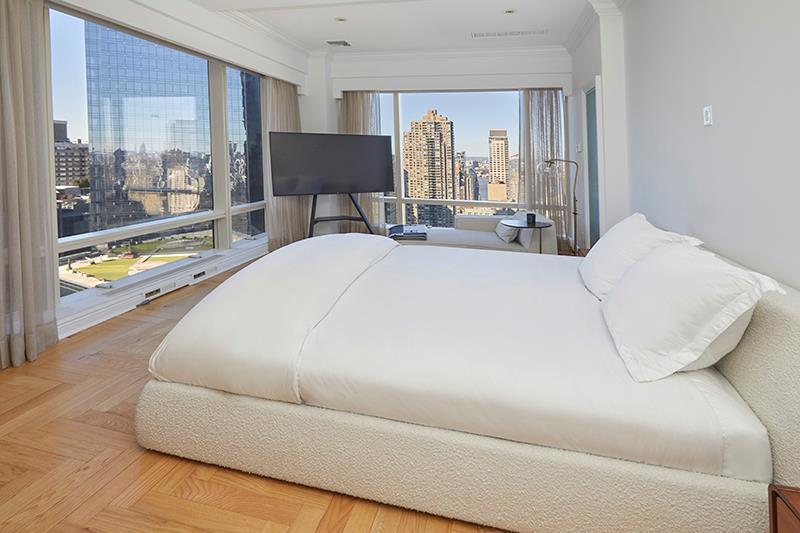 1 Central Park West, Unit 40CD Manhattan, NY 10023 - Photo 7 of 15 a bed sitting in a spacious bedroom next to a window