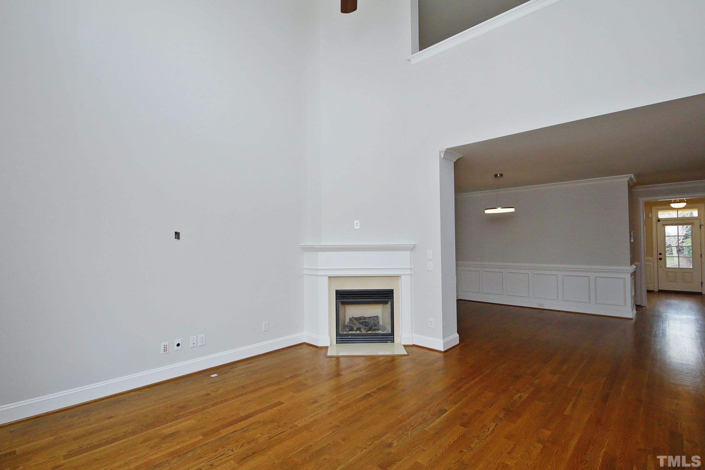 143 Cofield Circle Durham, NC 27707 - Photo 12 of 43 a view of empty room with wooden floor and fireplace
