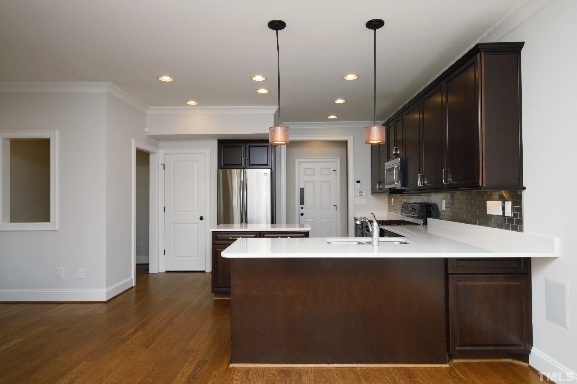 143 Cofield Circle Durham, NC 27707 - Photo 14 of 43 a large kitchen with kitchen island a sink stainless steel appliances and cabinets