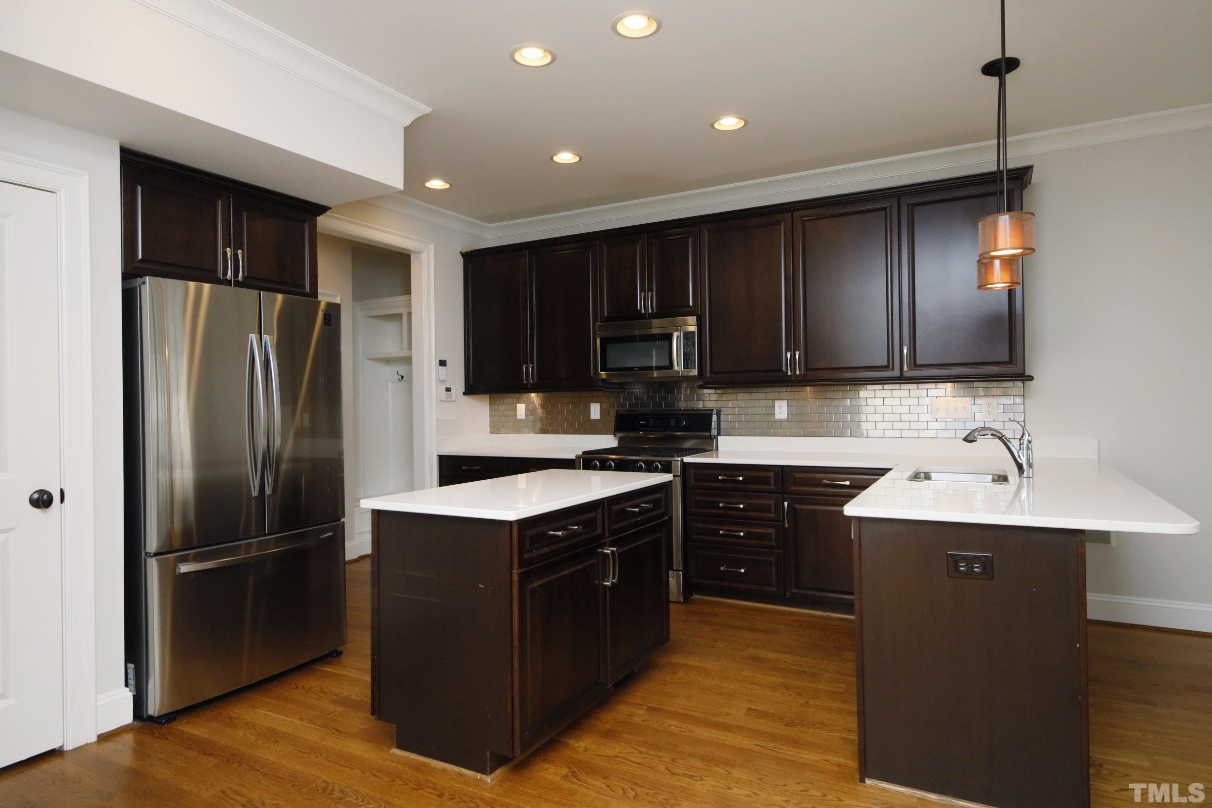 143 Cofield Circle Durham, NC 27707 - Photo 15 of 43 a kitchen with kitchen island a sink stainless steel appliances and cabinets