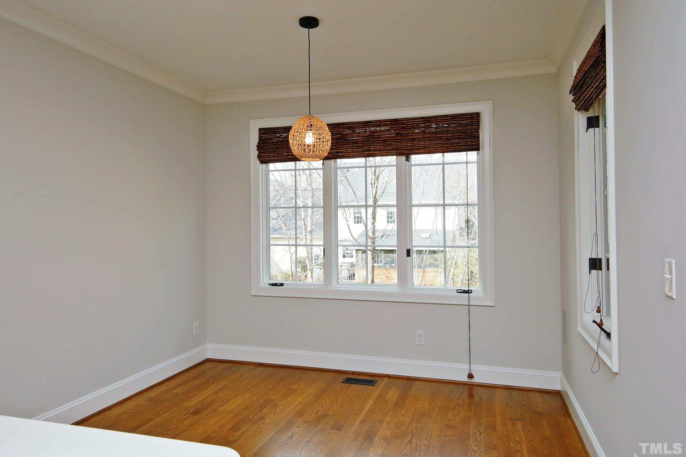 143 Cofield Circle Durham, NC 27707 - Photo 19 of 43 a view of an empty room with a window and wooden floor