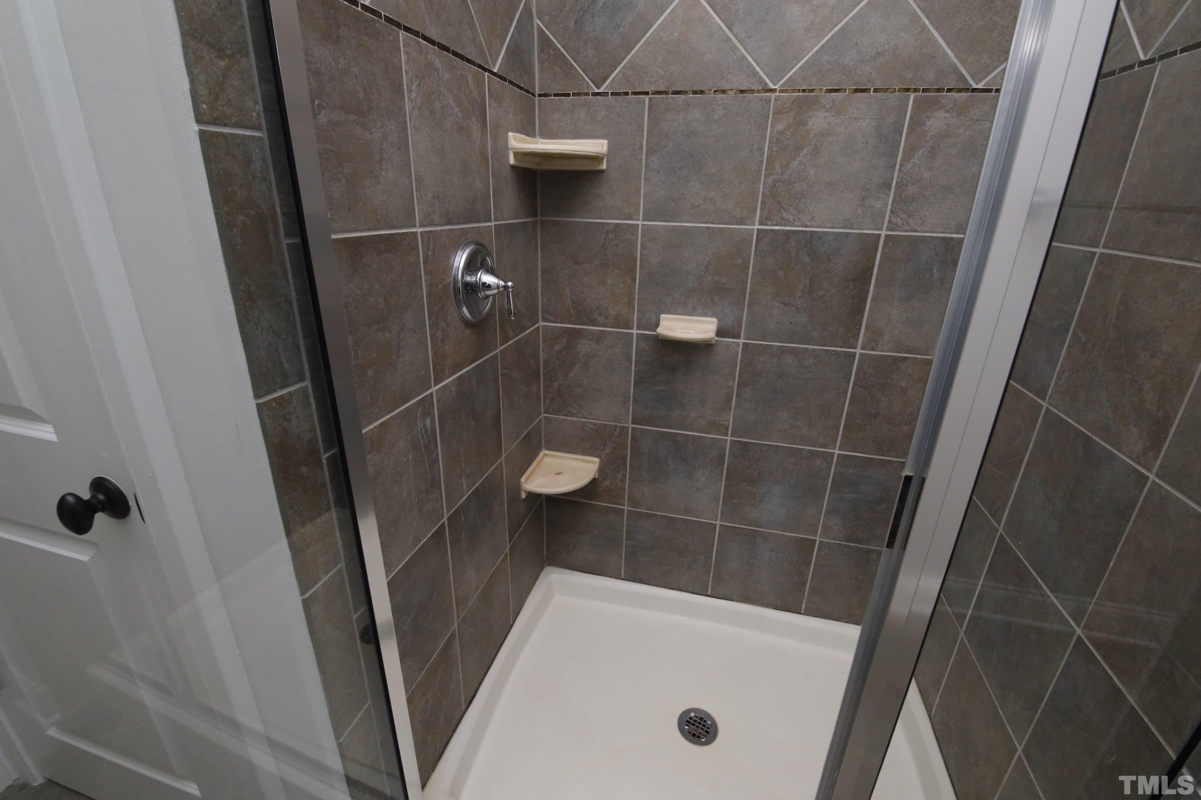 143 Cofield Circle Durham, NC 27707 - Photo 32 of 43 a bathroom with a tub and a shower