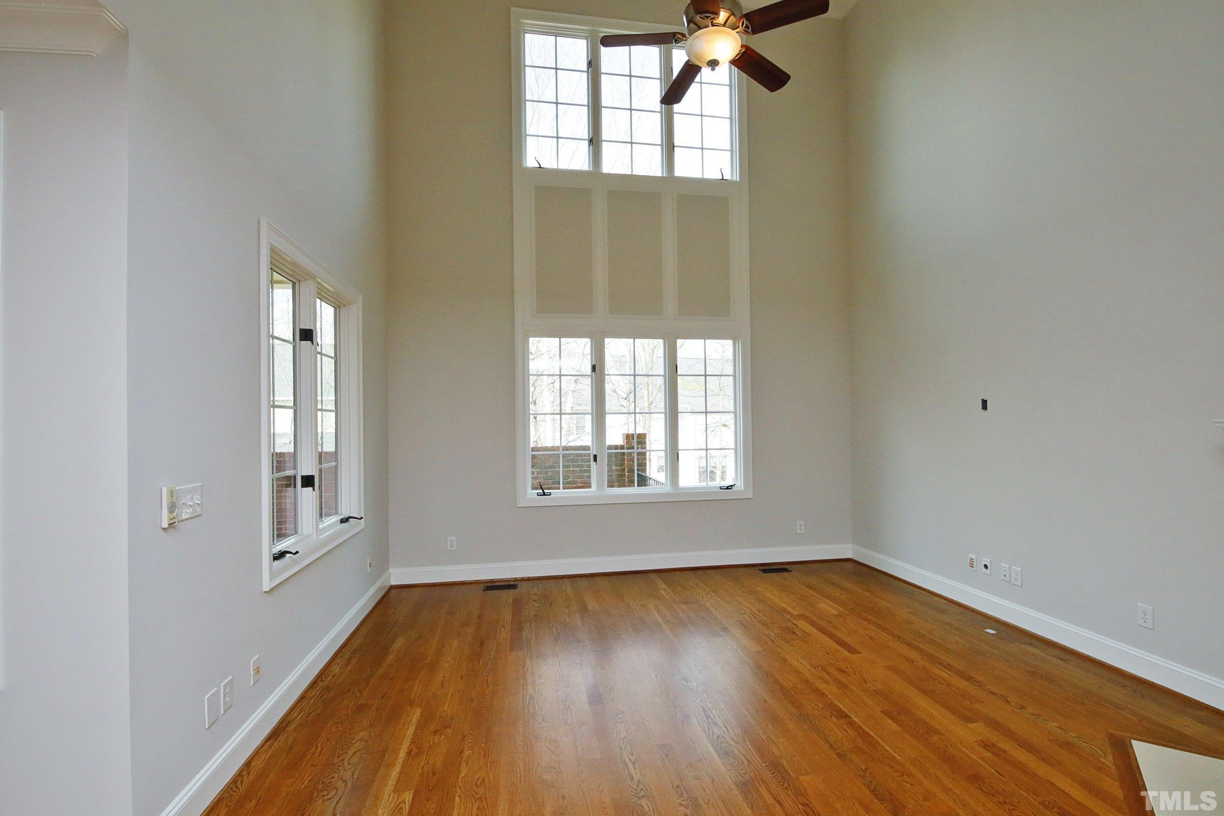 143 Cofield Circle Durham, NC 27707 - Photo 10 of 43 an empty room with wooden floor and windows