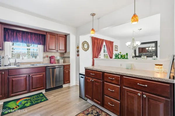 a kitchen with granite countertop a sink and a wooden cabinets