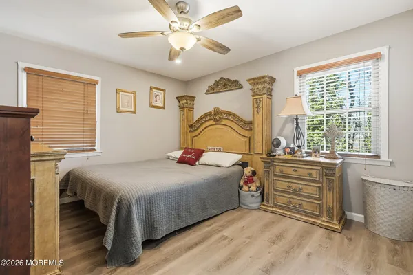 a bedroom with a bed dresser and a window